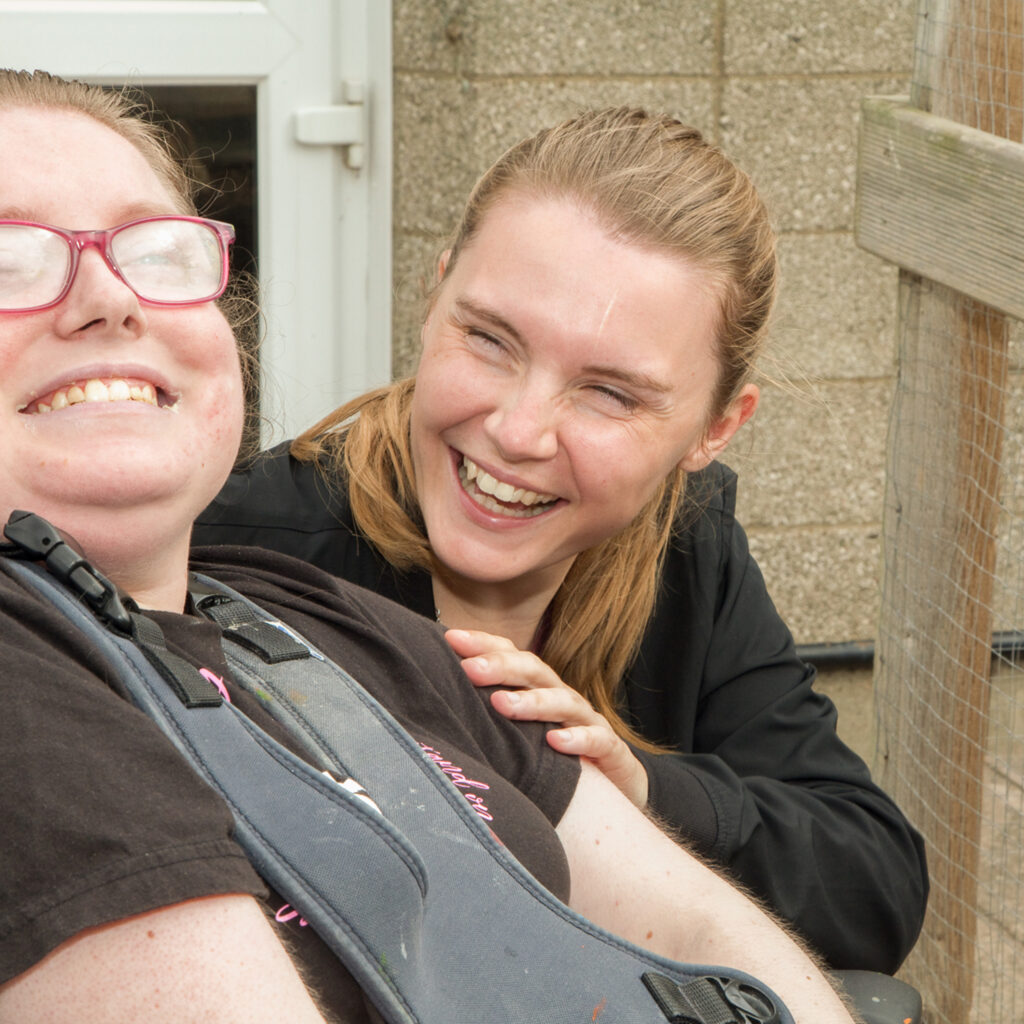 Care worker shares a laugh with a patient.